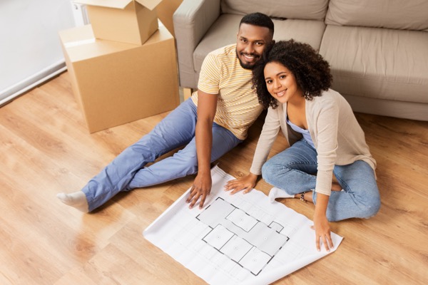 Couple sitting on floor in home 